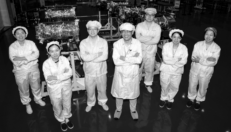 Technicians working on the Jilin-1 Gaofen 03 satellites pose for a photo at a Chang Guang Satellite Technology Co. workshop in northeast China's Jilin Province, on 3 August 2022.